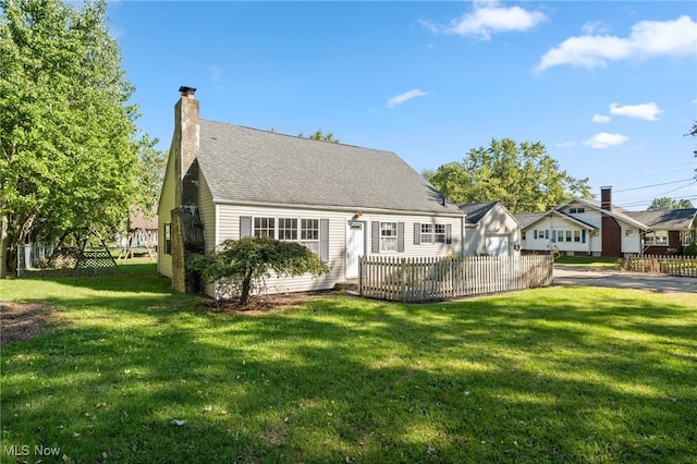 rear view of house with a yard