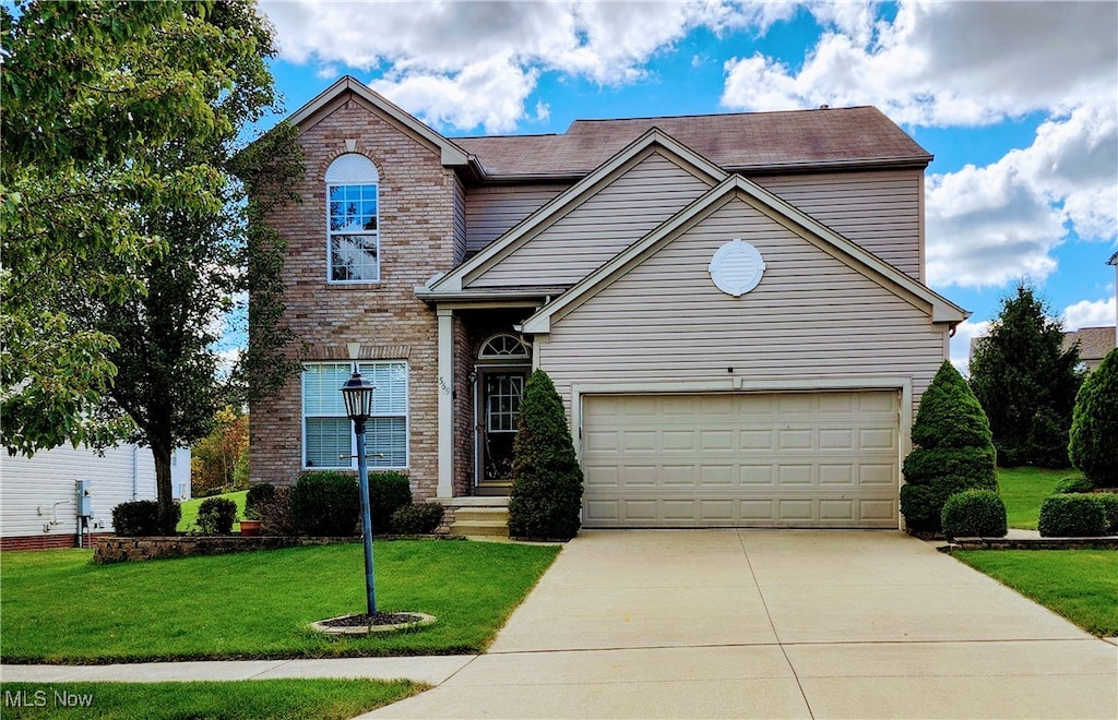 front facade with a front yard and a garage