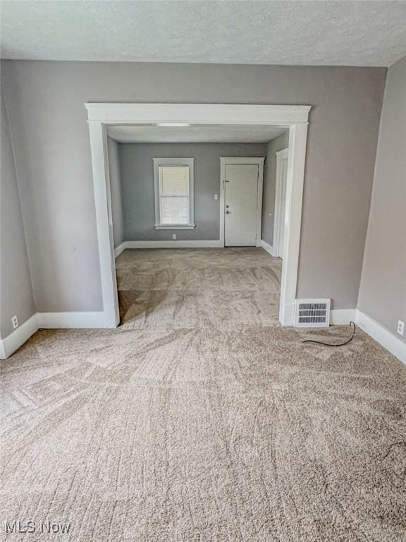 1504 W 19th St, Lorain, OH 44052 - empty room featuring carpet floors and a textured ceiling