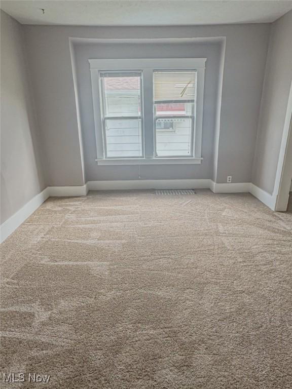 1504 W 19th St, Lorain, OH 44052 - carpeted empty room featuring healthy amount of natural light