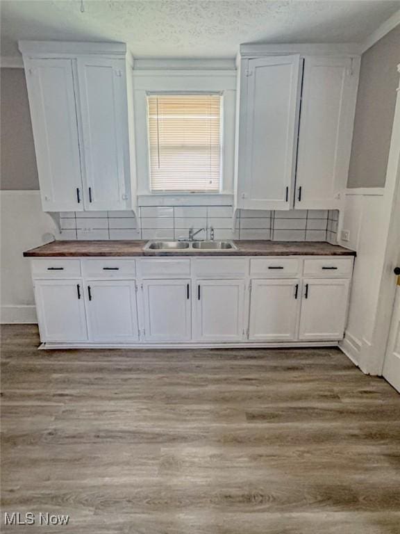 1504 W 19th St, Lorain, OH 44052 - kitchen featuring wood counters, white cabinets, light wood-type flooring, and a textured ceiling