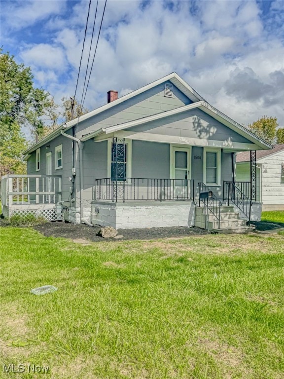 bungalow-style home with a front yard and covered porch