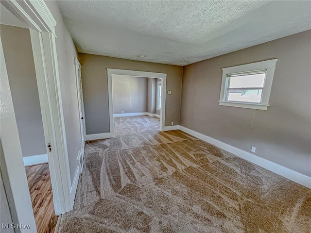 1504 W 19th St, Lorain, OH 44052 - spare room with a textured ceiling and carpet