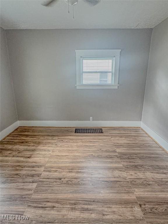 1504 W 19th St, Lorain, OH 44052 - unfurnished room with wood finished floors and ceiling fan