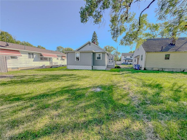 1504 W 19th St, Lorain, OH 44052 - back of house with a lawn