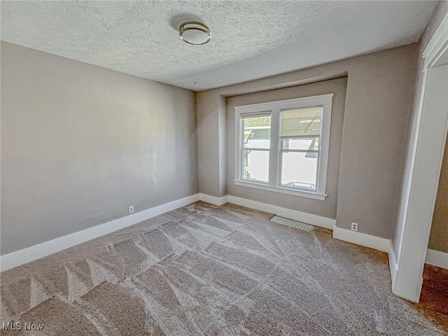1504 W 19th St, Lorain, OH 44052 - carpeted empty room with baseboards and a textured ceiling