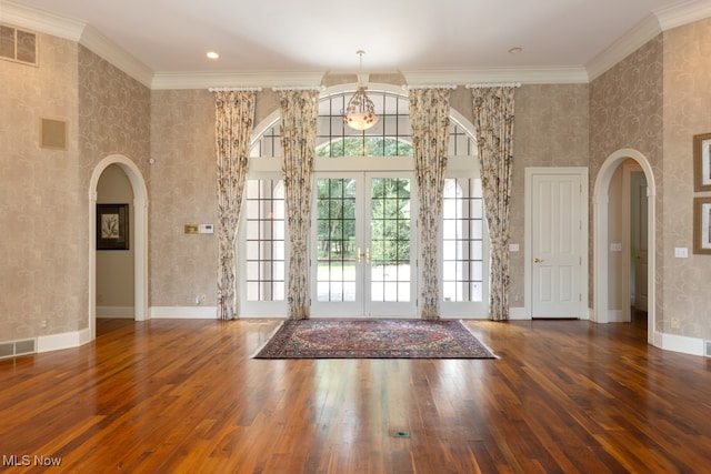 entrance foyer with french doors, dark hardwood / wood-style floors, and ornamental molding