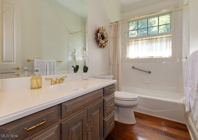 full bathroom with vanity, shower / bath combo with shower curtain, hardwood / wood-style flooring, crown molding, and toilet