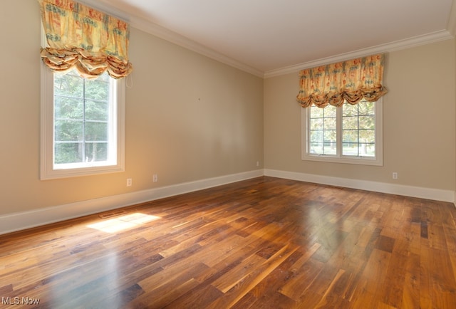 unfurnished room featuring dark hardwood / wood-style floors and ornamental molding