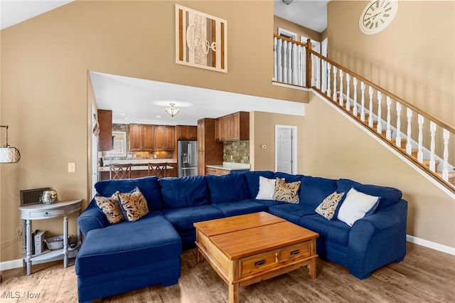 living room with a high ceiling and hardwood / wood-style flooring