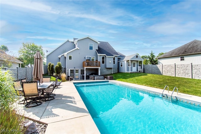 view of pool with a patio and a lawn