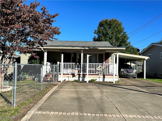 view of front of home with covered porch and a carport