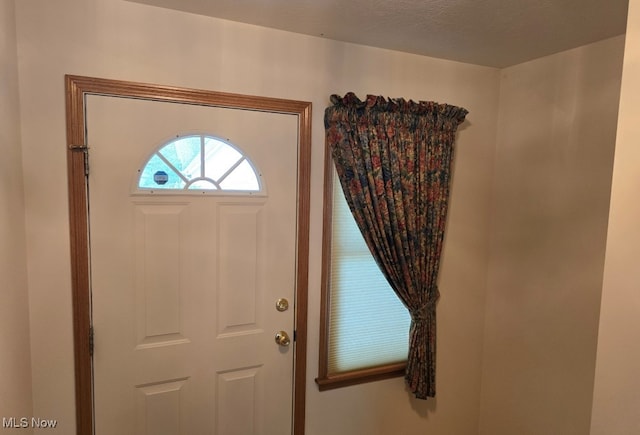 foyer entrance featuring a textured ceiling