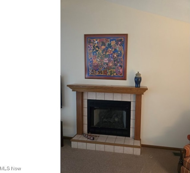 room details with a tiled fireplace and carpet