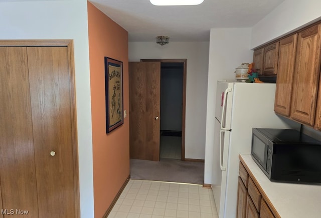 kitchen featuring light carpet