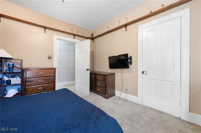 bedroom featuring light colored carpet