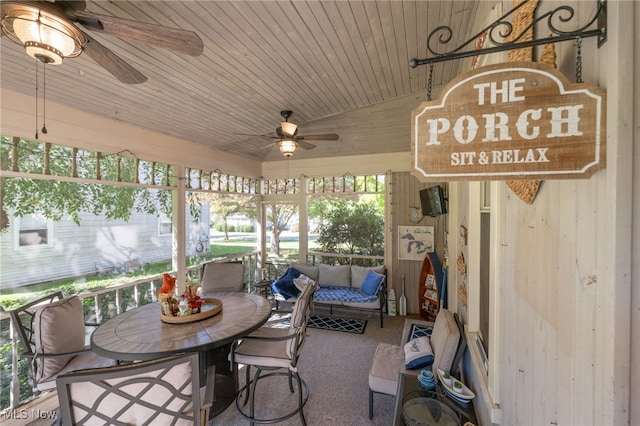 sunroom with ceiling fan and wooden ceiling