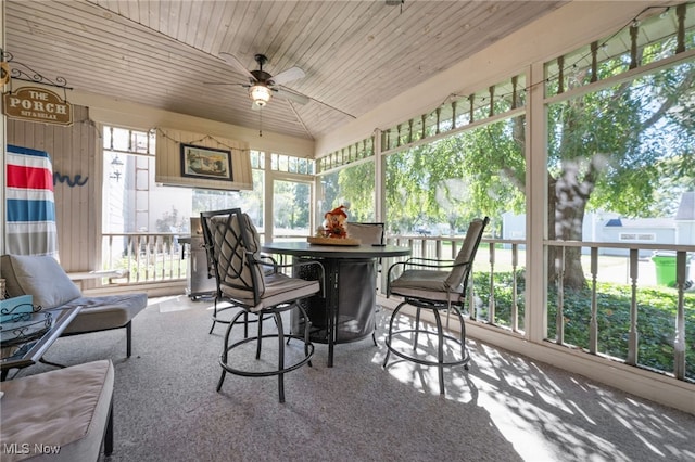 sunroom featuring ceiling fan, wood ceiling, and vaulted ceiling