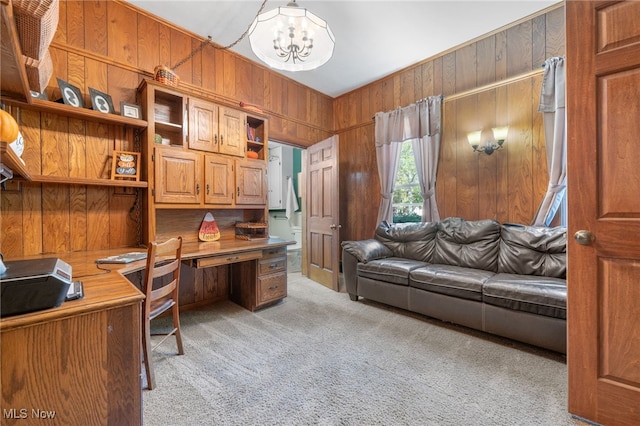 carpeted office featuring a notable chandelier and wood walls