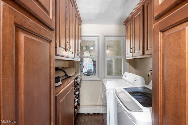 washroom featuring a textured ceiling, washing machine and dryer, and dark wood-type flooring