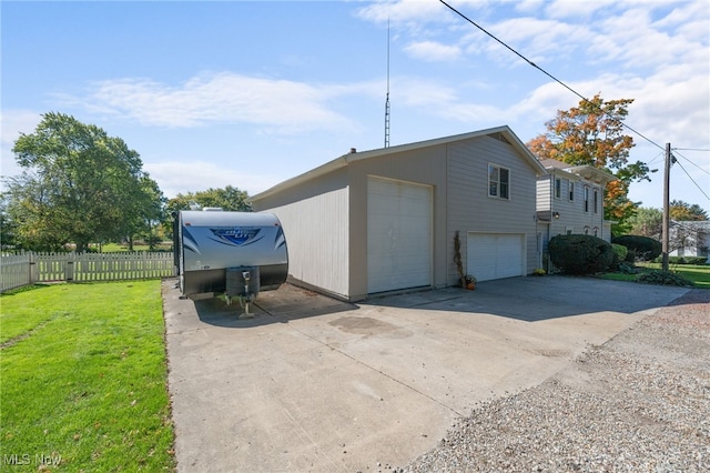 view of home's exterior featuring a garage and a lawn