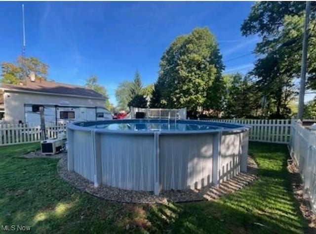 view of swimming pool featuring a lawn