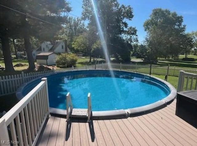 view of swimming pool with a wooden deck