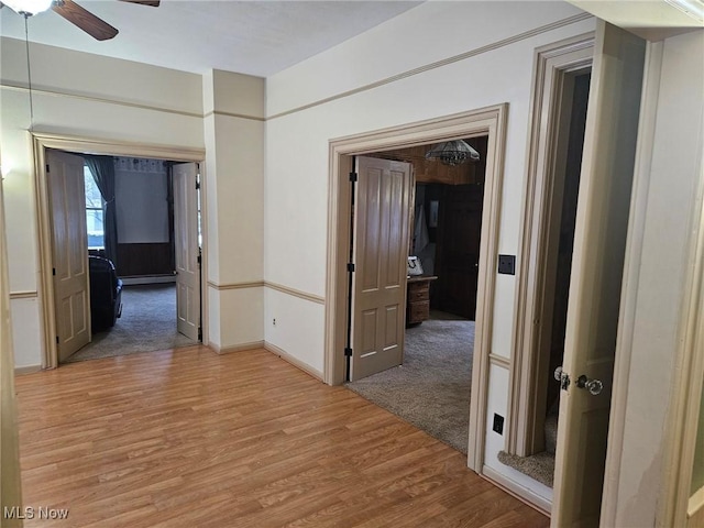 hallway with baseboard heating and carpet