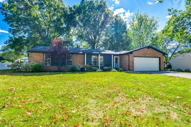 ranch-style home featuring a front lawn and a garage