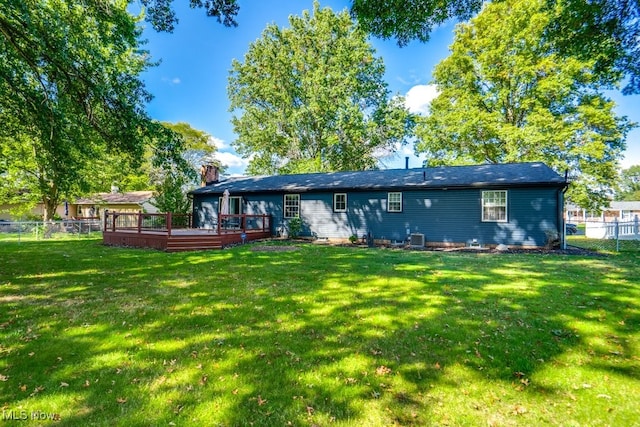 back of house with a yard and a wooden deck