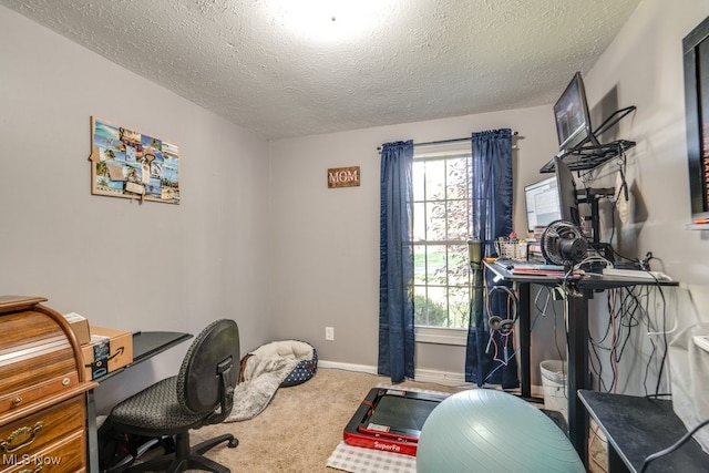 home office featuring carpet and a textured ceiling