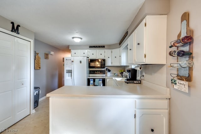 kitchen featuring white refrigerator with ice dispenser, stainless steel range with electric stovetop, kitchen peninsula, and white cabinetry