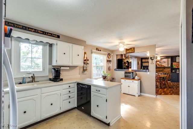 kitchen featuring white cabinets, black dishwasher, and kitchen peninsula