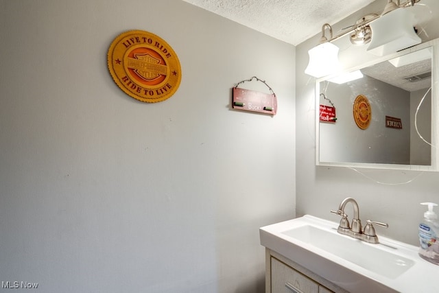 bathroom featuring vanity and a textured ceiling