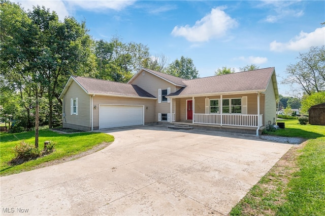 view of front of property with a garage, a front lawn, and covered porch