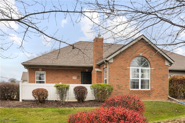 back of property featuring a lawn