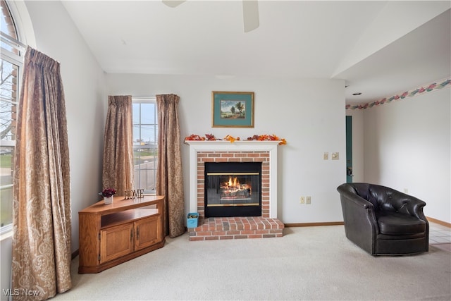 sitting room with a fireplace, carpet, and lofted ceiling