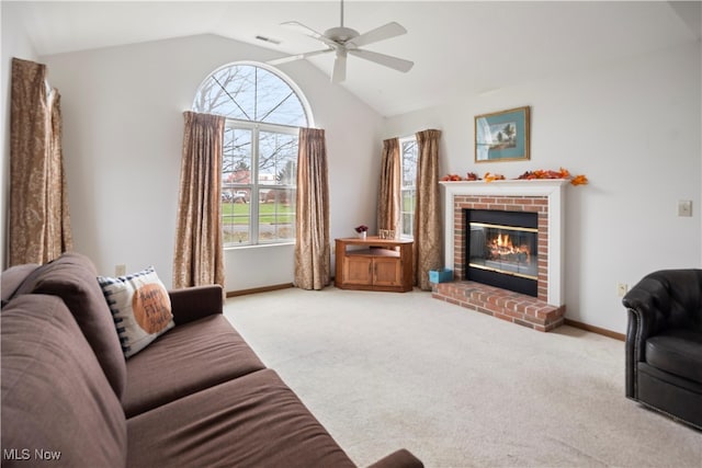 carpeted living room with ceiling fan, lofted ceiling, and a brick fireplace