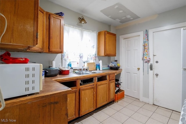 kitchen featuring sink and light tile patterned floors