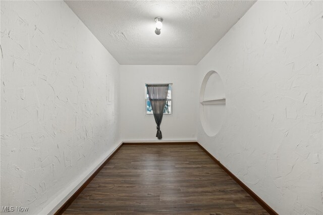 interior space with dark hardwood / wood-style floors and a textured ceiling