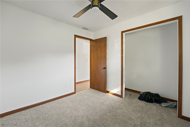 unfurnished bedroom featuring light colored carpet and ceiling fan