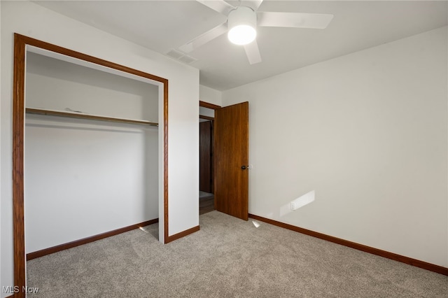 unfurnished bedroom with light colored carpet, a closet, and ceiling fan