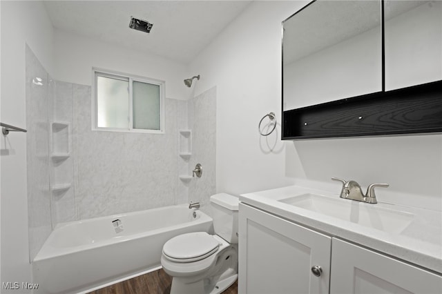 full bathroom with toilet, tiled shower / bath combo, vanity, and wood-type flooring