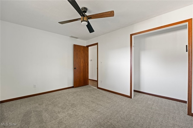 unfurnished bedroom featuring a closet, light colored carpet, and ceiling fan