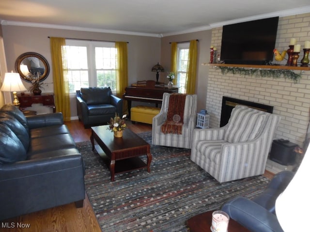 living room featuring a brick fireplace, ornamental molding, and dark hardwood / wood-style flooring