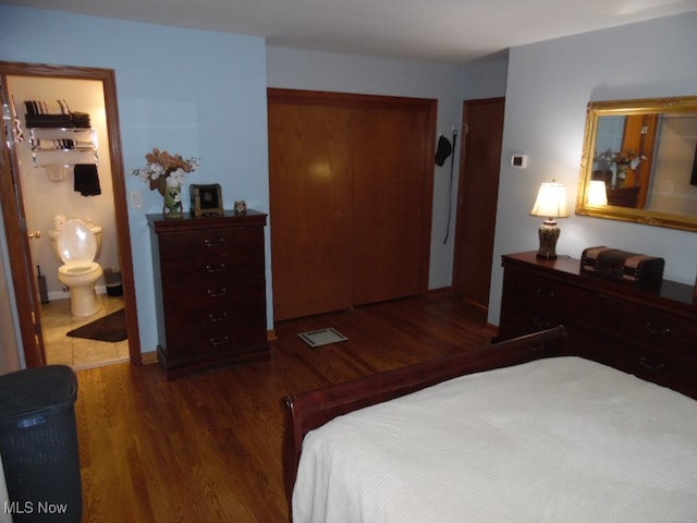 bedroom featuring dark hardwood / wood-style floors and ensuite bathroom