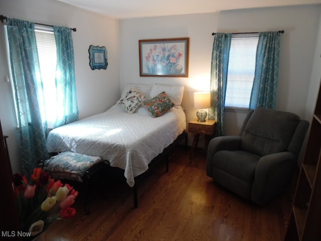 bedroom featuring hardwood / wood-style floors and multiple windows