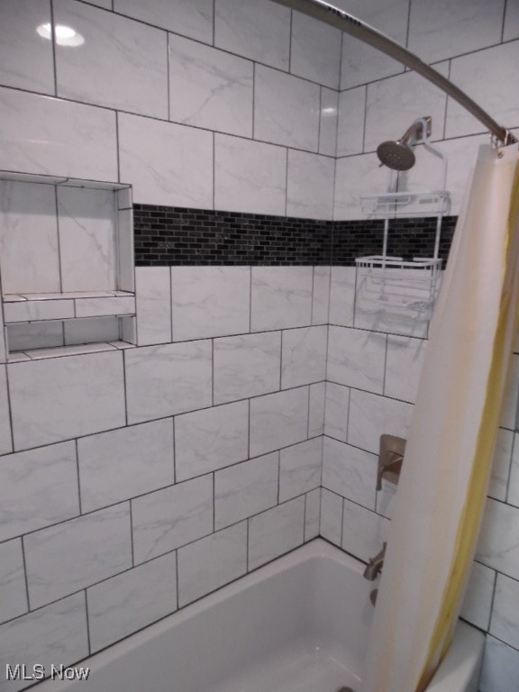 bathroom with shower / bathtub combination with curtain