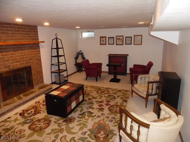 carpeted living room featuring a fireplace and a textured ceiling