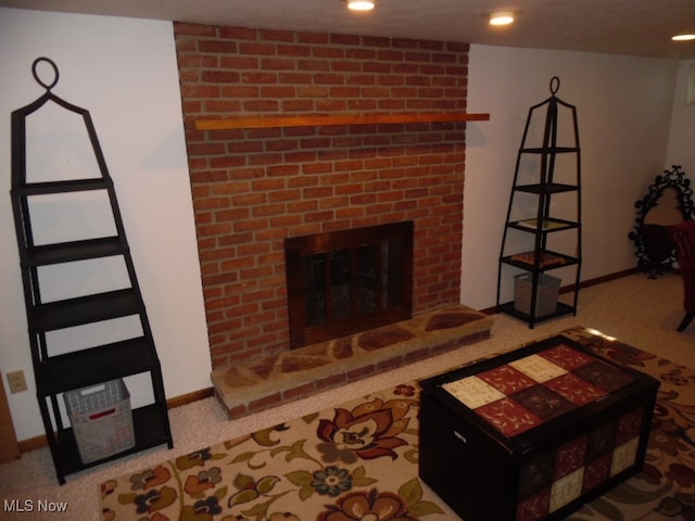 living room featuring a fireplace and carpet flooring